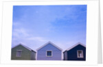 Beach huts in a row against sky by Assaf Frank